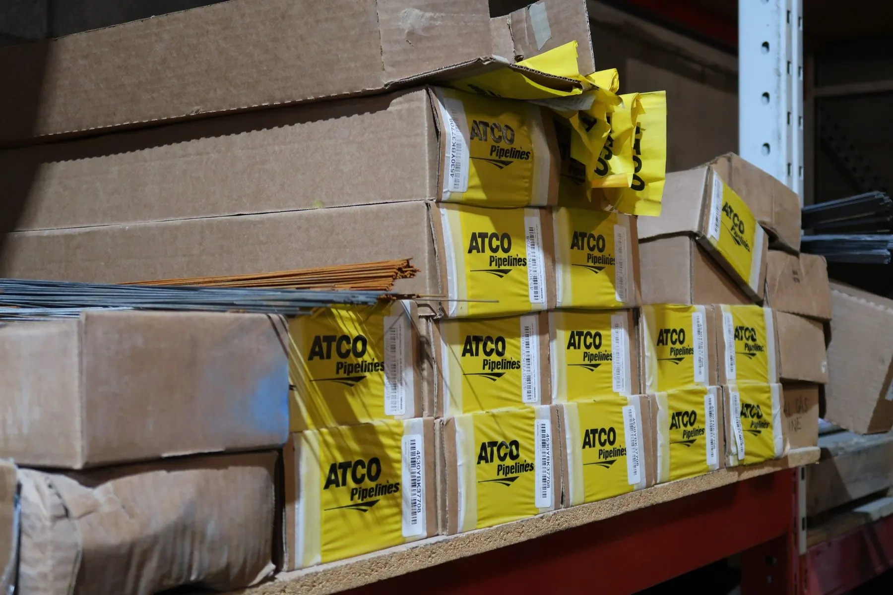 Boxed locate flags stacked on warehouse racking at the CLI facility