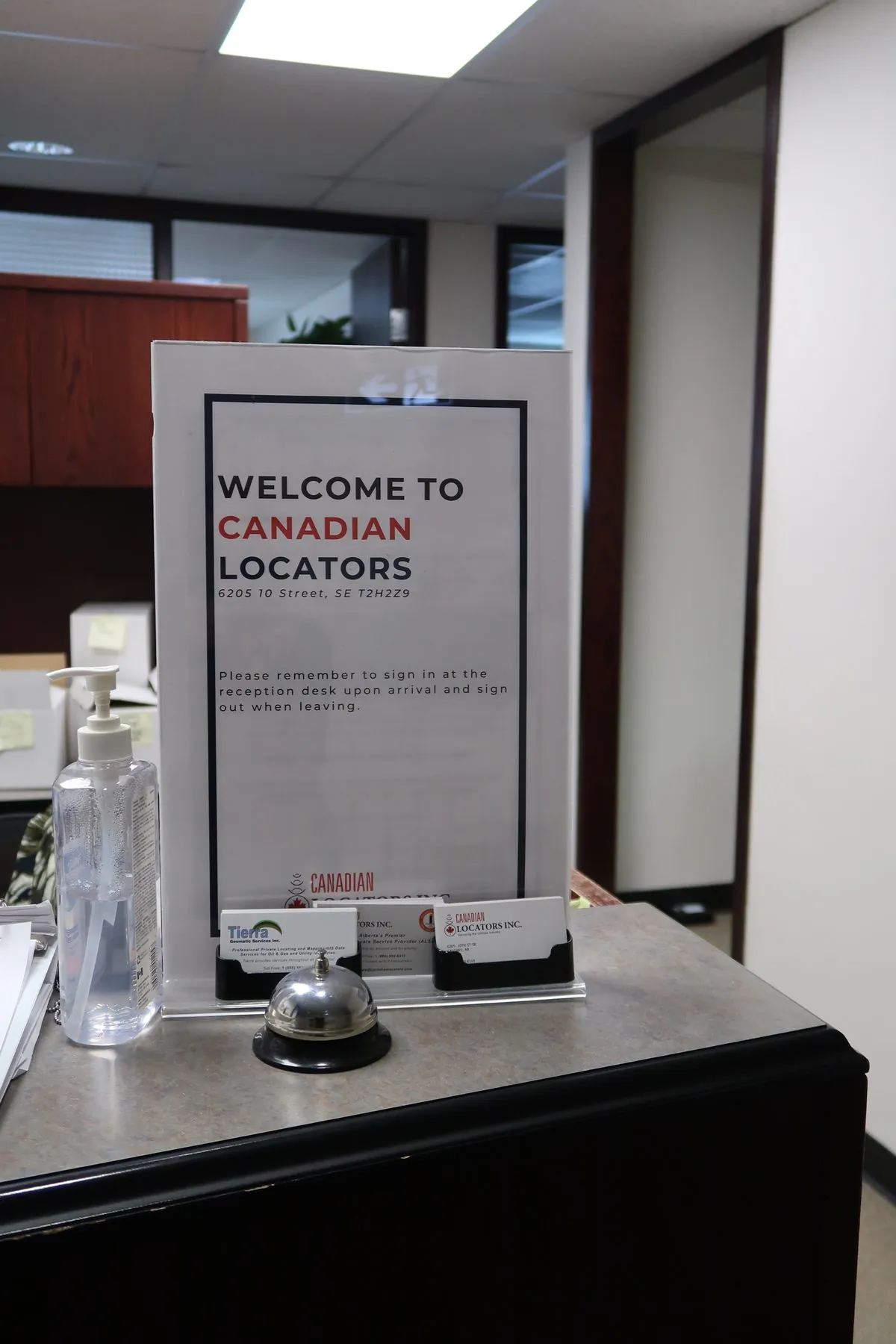 Welcome to Canadian Locators sign-in notice at the reception desk