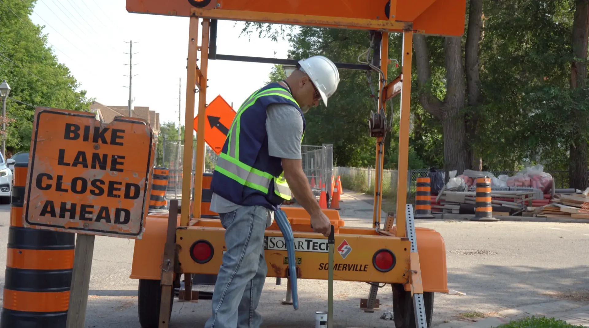 CLI field technician locating beside a municipal roadwork trailer