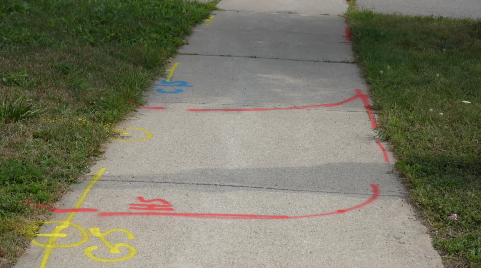 Multi-colour utility paint markings on the ground
